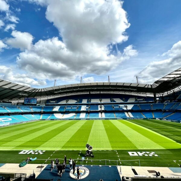 A view of the iconic Etihad Stadium in Manchester, United Kingdom, showcasing its vibrant football field.