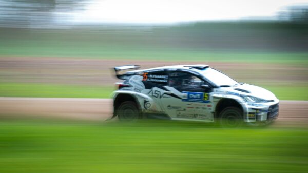 A blurry photo of a car driving on a track