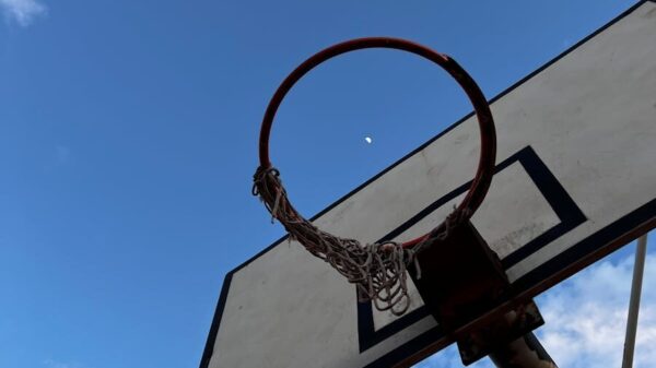 Basketball hoop silhouetted against a clear sky with the moon visible in Antalya, Türkiye.
