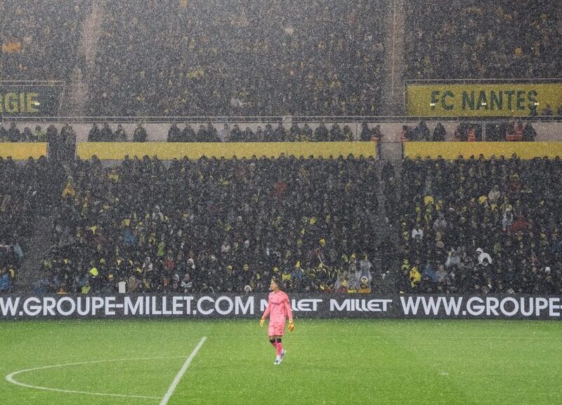 soccer players on field during daytime