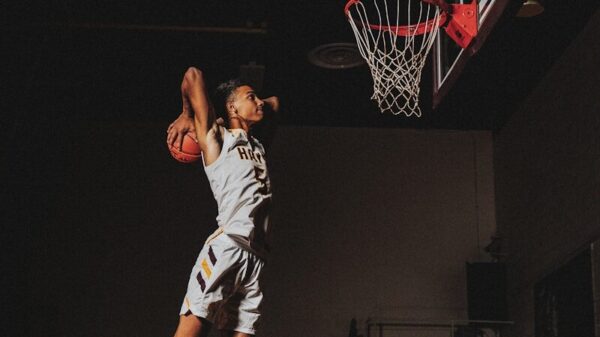 2 boys playing basketball on basketball court