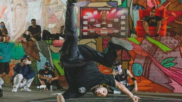 Dynamic breakdance competition in a graffiti-filled urban venue, capturing the energy and artistry of street dance culture.