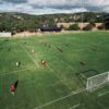 Aerial shot of soccer game at a grassy field in Bedford Park, SA, Australia.