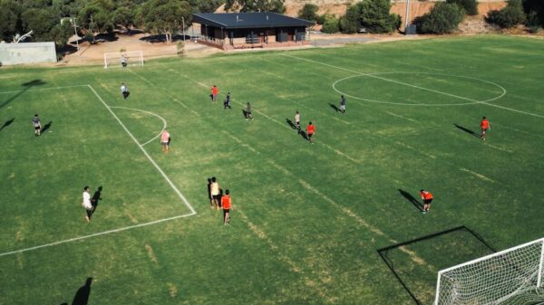 Aerial shot of soccer game at a grassy field in Bedford Park, SA, Australia.