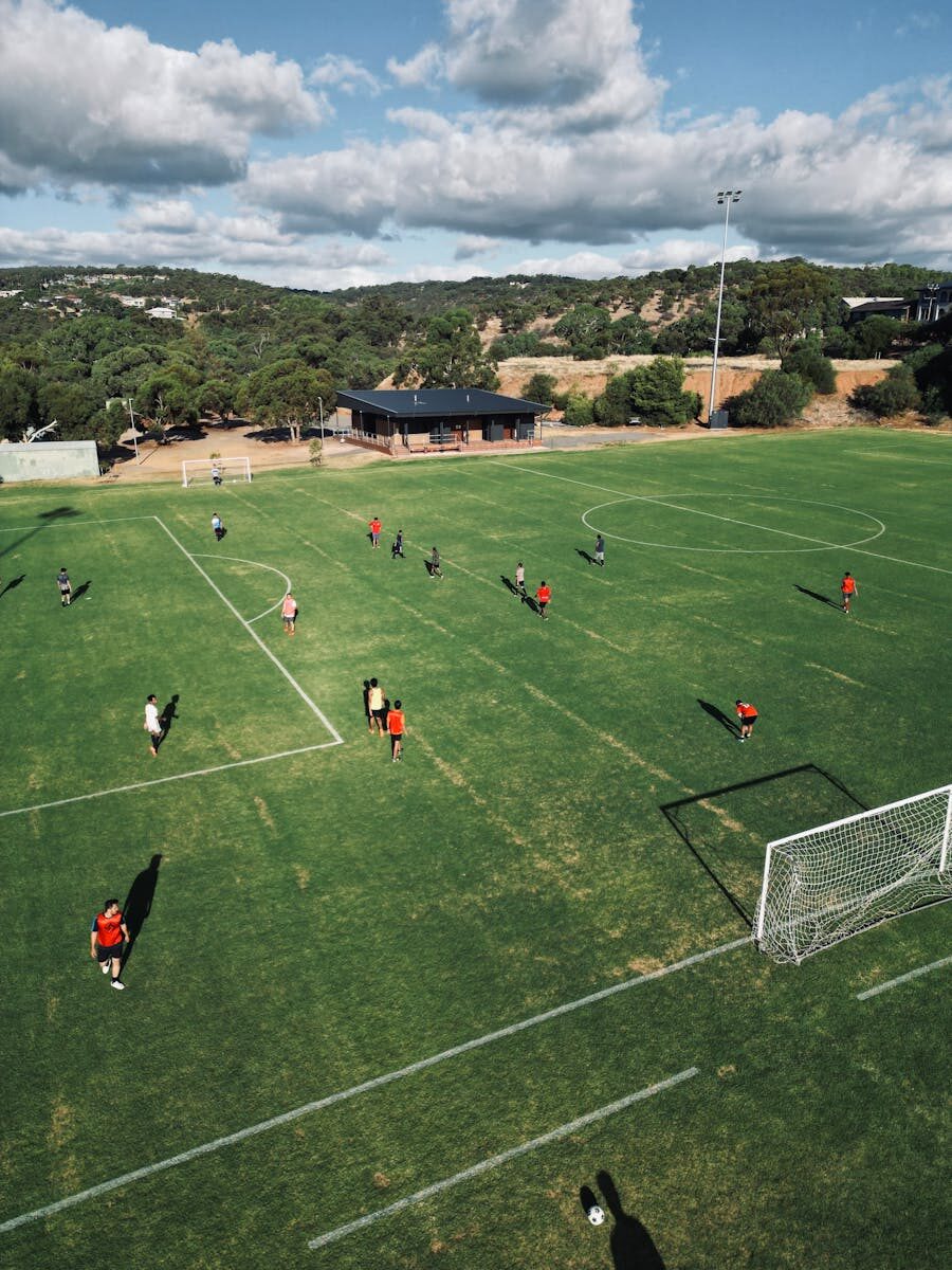 Aerial shot of soccer game at a grassy field in Bedford Park, SA, Australia.