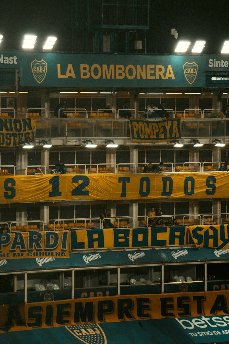 Vibrant atmosphere inside La Bombonera stadium, showcasing enthusiastic soccer fans and iconic banners.