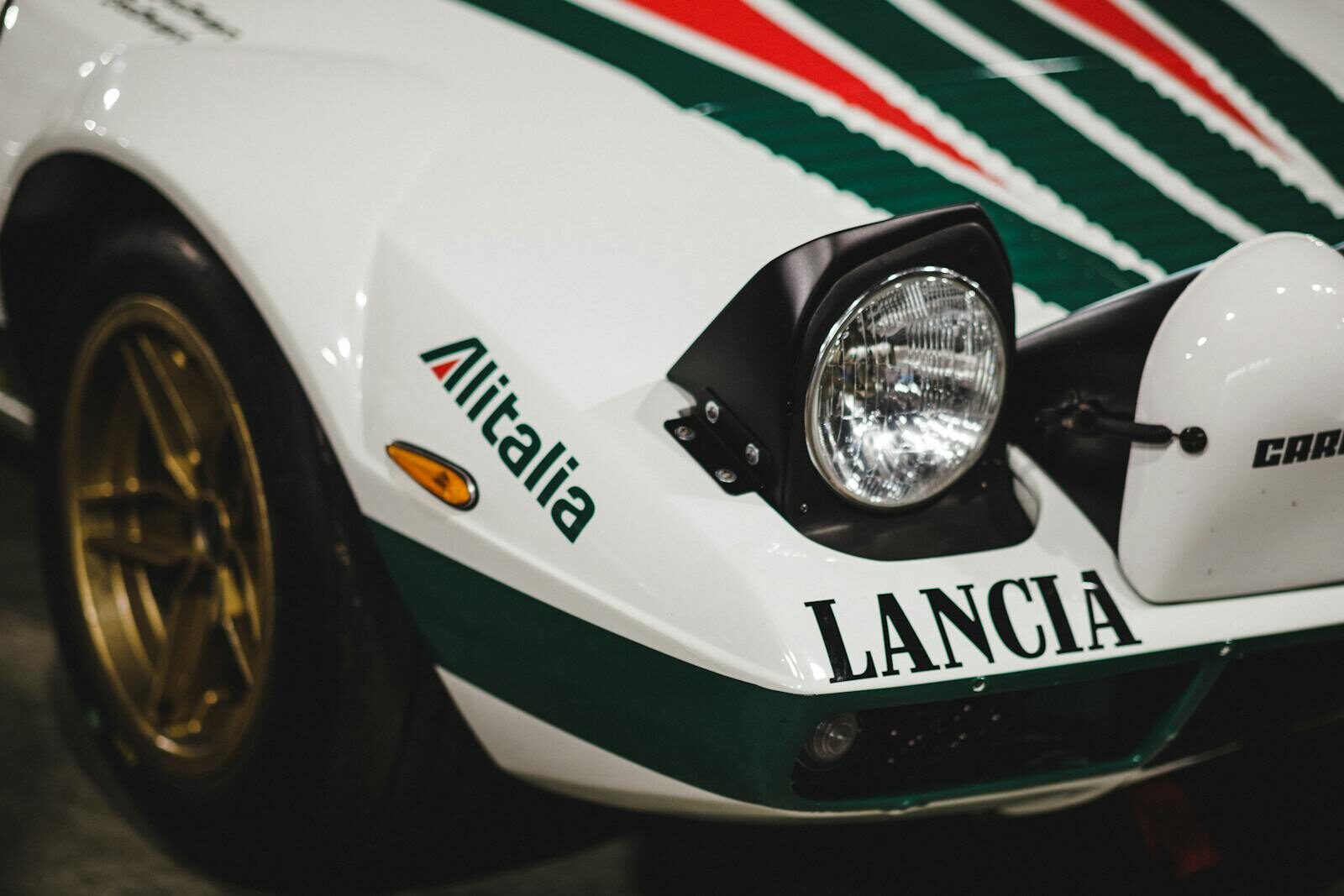 Detailed view of a Lancia Stratos sports car with Alitalia branding, showcasing its classic rally design.