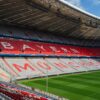 Explore the iconic Allianz Arena in Munich, home to FC Bayern, captured empty and sunlit.