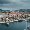 Stunning aerial view of Split's waterfront showcasing boats, buildings, and iconic bell tower.