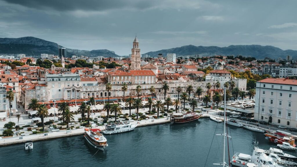 Stunning aerial view of Split's waterfront showcasing boats, buildings, and iconic bell tower.