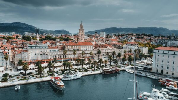 Stunning aerial view of Split's waterfront showcasing boats, buildings, and iconic bell tower.