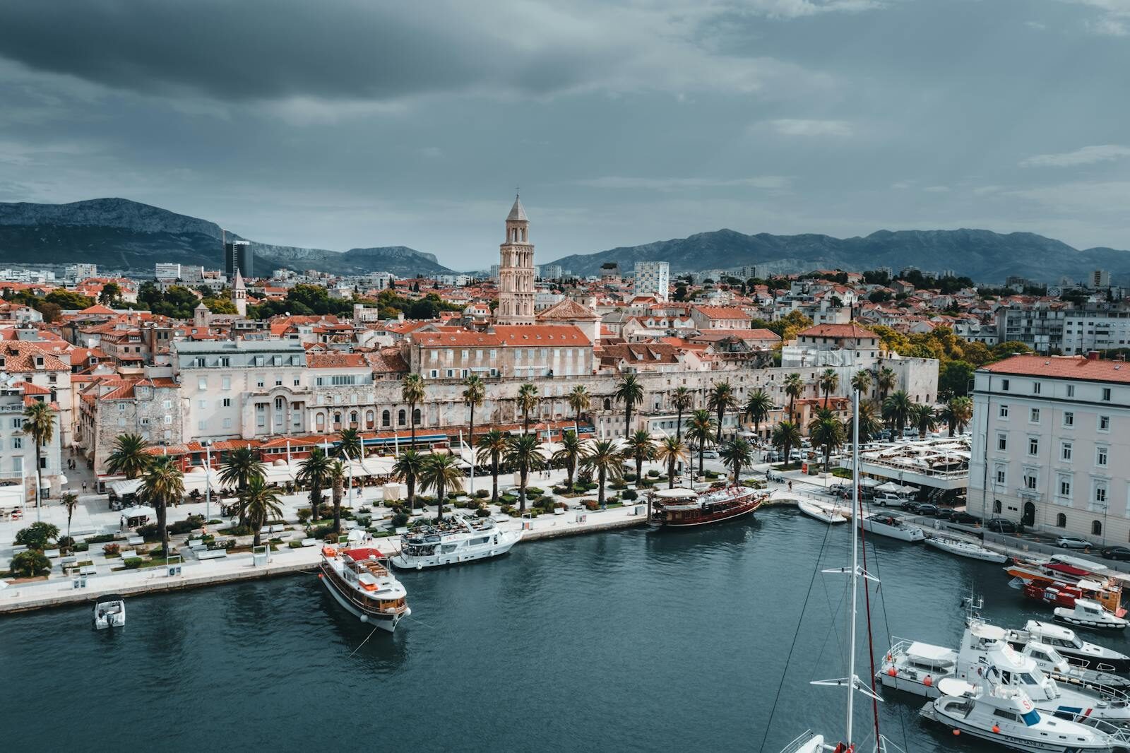 Stunning aerial view of Split's waterfront showcasing boats, buildings, and iconic bell tower.
