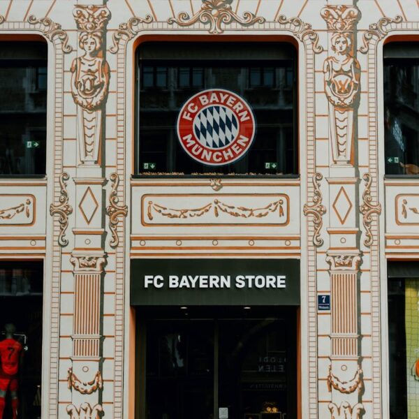 FC Bayern Store front in Munich showcasing the iconic Bayern Munich logo and architectural details.