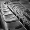 Black and white image of empty stadium seats with a focus on the symmetry and structure.