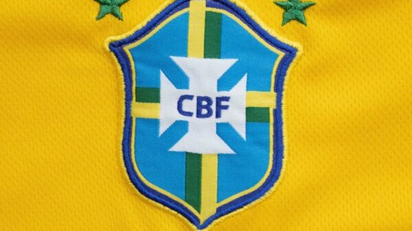 Close-up of the Brazilian football team emblem on a vibrant yellow jersey.