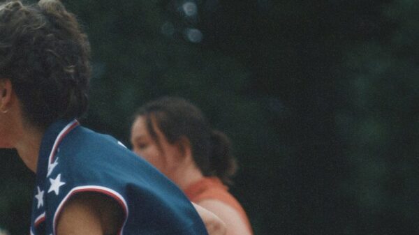 A man is playing basketball in front of a crowd