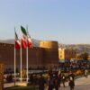Karim Khan Citadel with Iranian flags in Shiraz, Iran at sunset.
