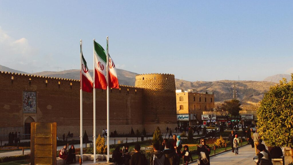 Karim Khan Citadel with Iranian flags in Shiraz, Iran at sunset.