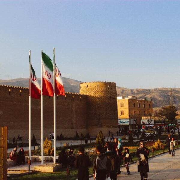 Karim Khan Citadel with Iranian flags in Shiraz, Iran at sunset.