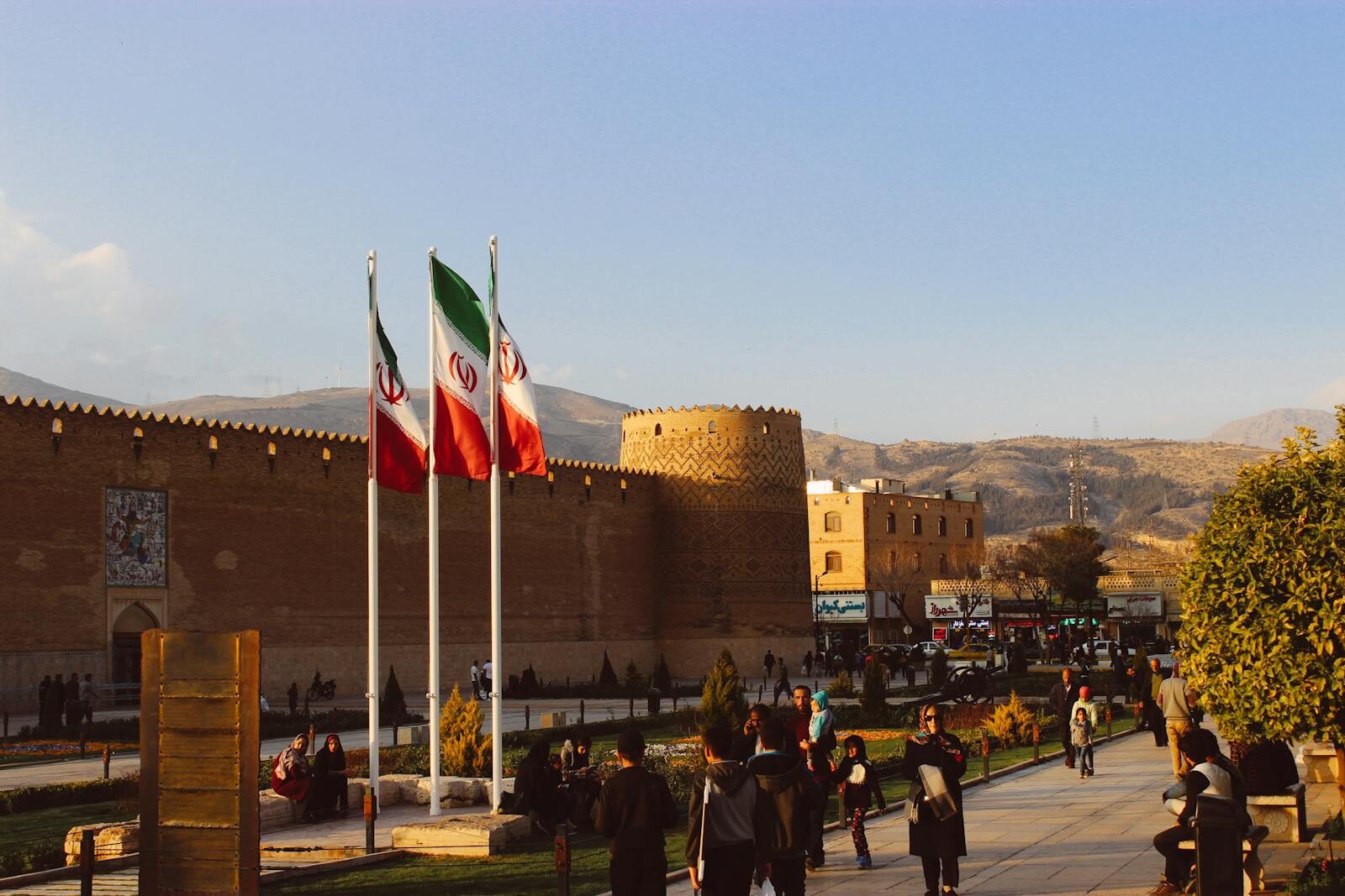 Karim Khan Citadel with Iranian flags in Shiraz, Iran at sunset.