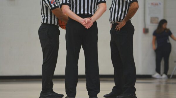 A group of men standing on top of a basketball court