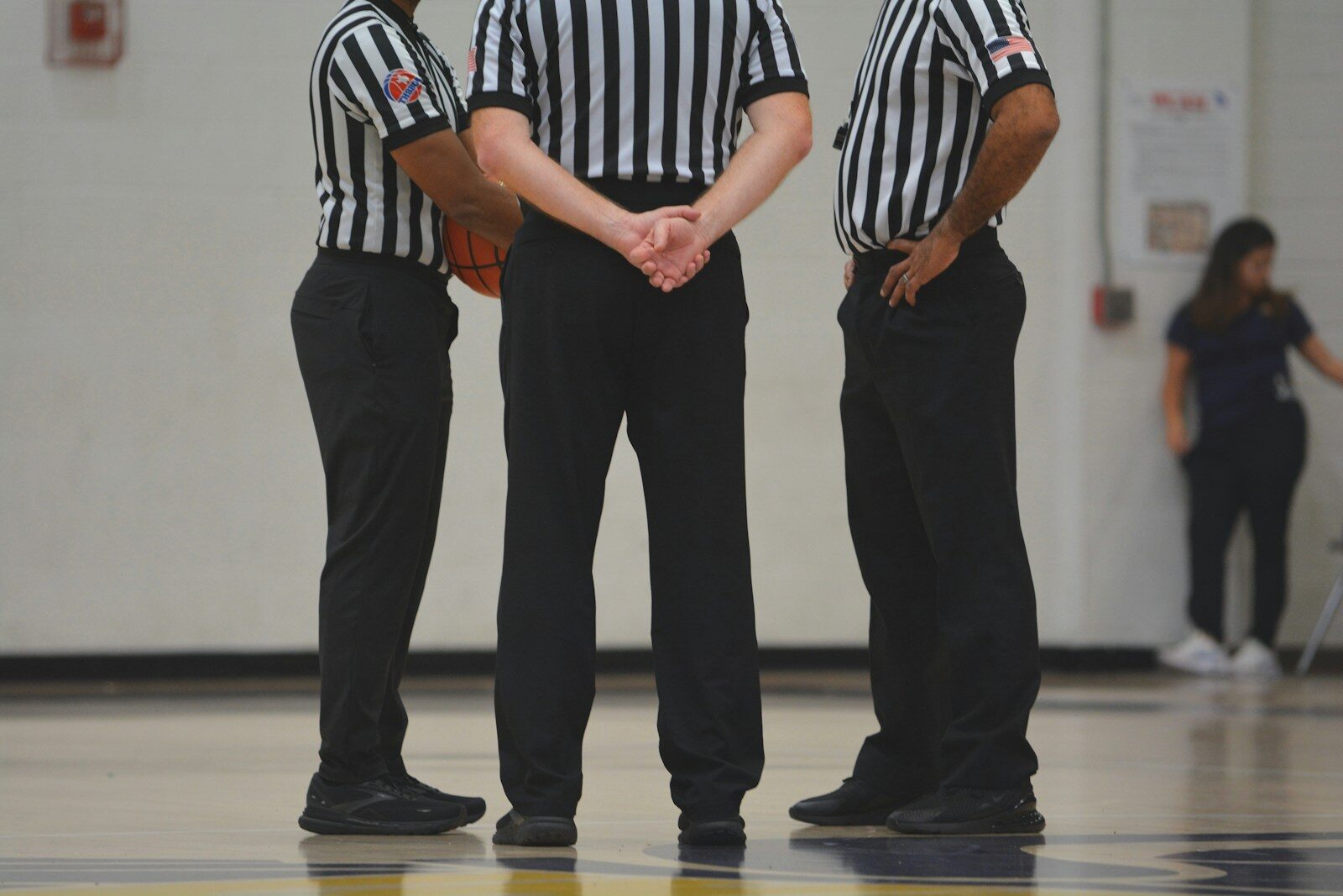 A group of men standing on top of a basketball court