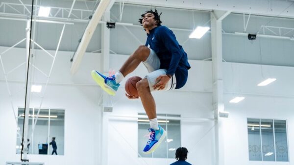 A man jumping up into the air while playing basketball