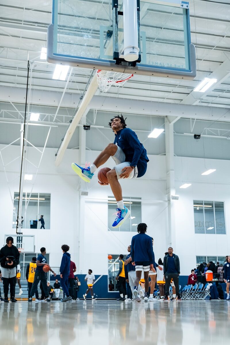 A man jumping up into the air while playing basketball