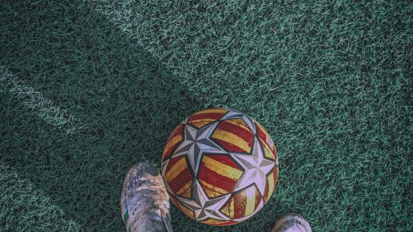 person in gray pants and gray shoes standing on green carpet