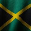 the flag of jamaica is waving in the wind