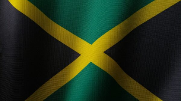 the flag of jamaica is waving in the wind