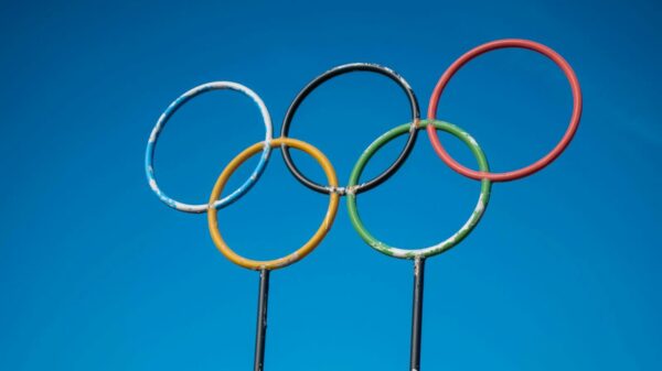 Olympic rings sculpture set against a clear blue sky in Lahti, Finland.