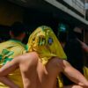a group of people in yellow shirts standing next to each other