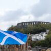 a scottish flag flying in front of a castle