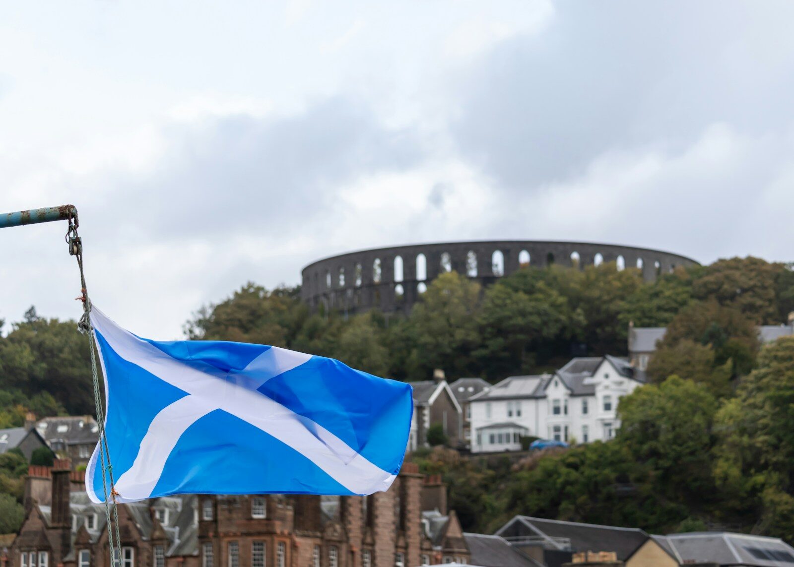 a scottish flag flying in front of a castle