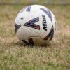 Close-up of a soccer ball on dry grass in Tipton, England. Perfect for sports and recreation themes.
