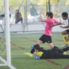 2 boys playing soccer on field during daytime