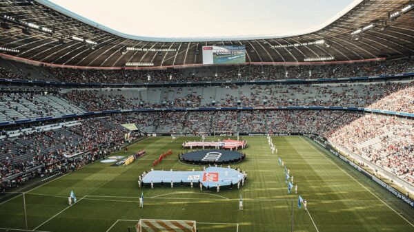 people watching football game during daytime