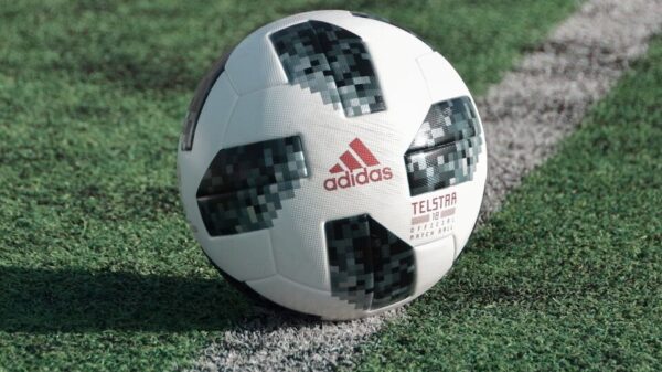 close-up photography of adidas soccer ball on field