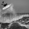 grayscale man surfing