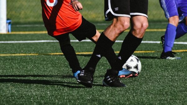 a kid kicks a football ball