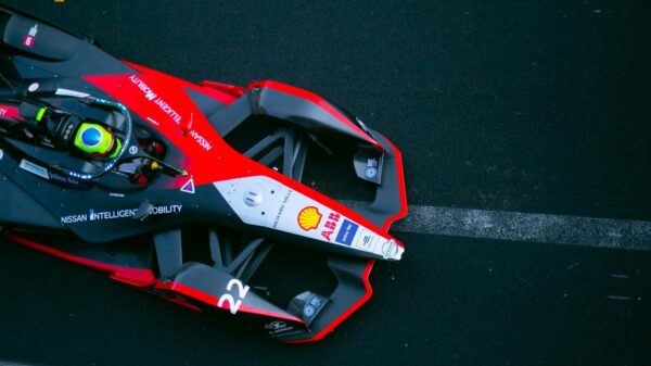 A dynamic top view of a Formula E car racing on a track in Ciudad de México.