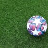 white blue and red soccer ball on green grass