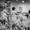 grayscale photo of basketball players in court