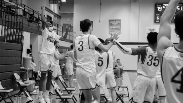 grayscale photo of basketball players in court