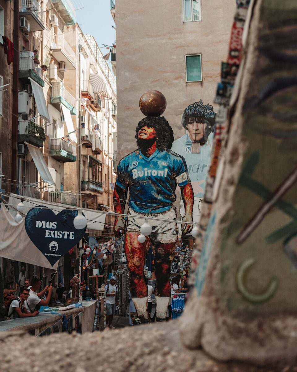 Giant mural of diego maradona in a narrow street