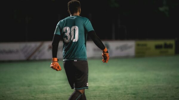 man in blue and white nike soccer jersey running on green grass field during daytime