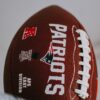 red and white football on white surface