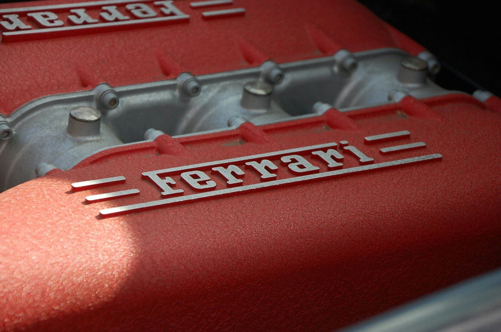 close-up photography of gray and red Ferrari engine