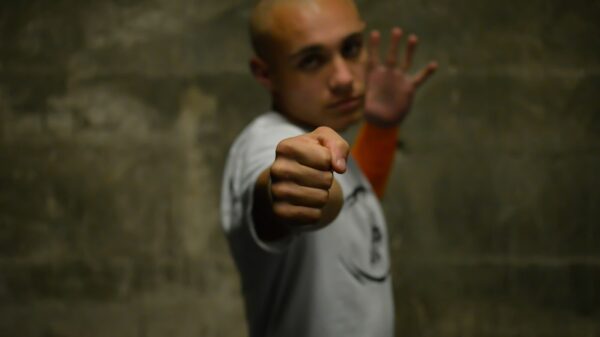 A man with a bald head pointing his finger at the camera